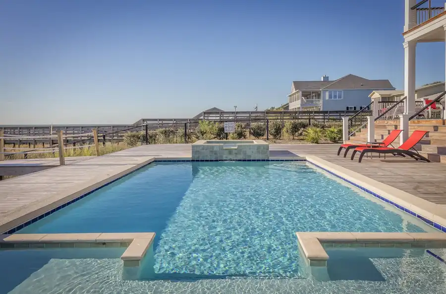 Residential pool with lounge chairs and open decking