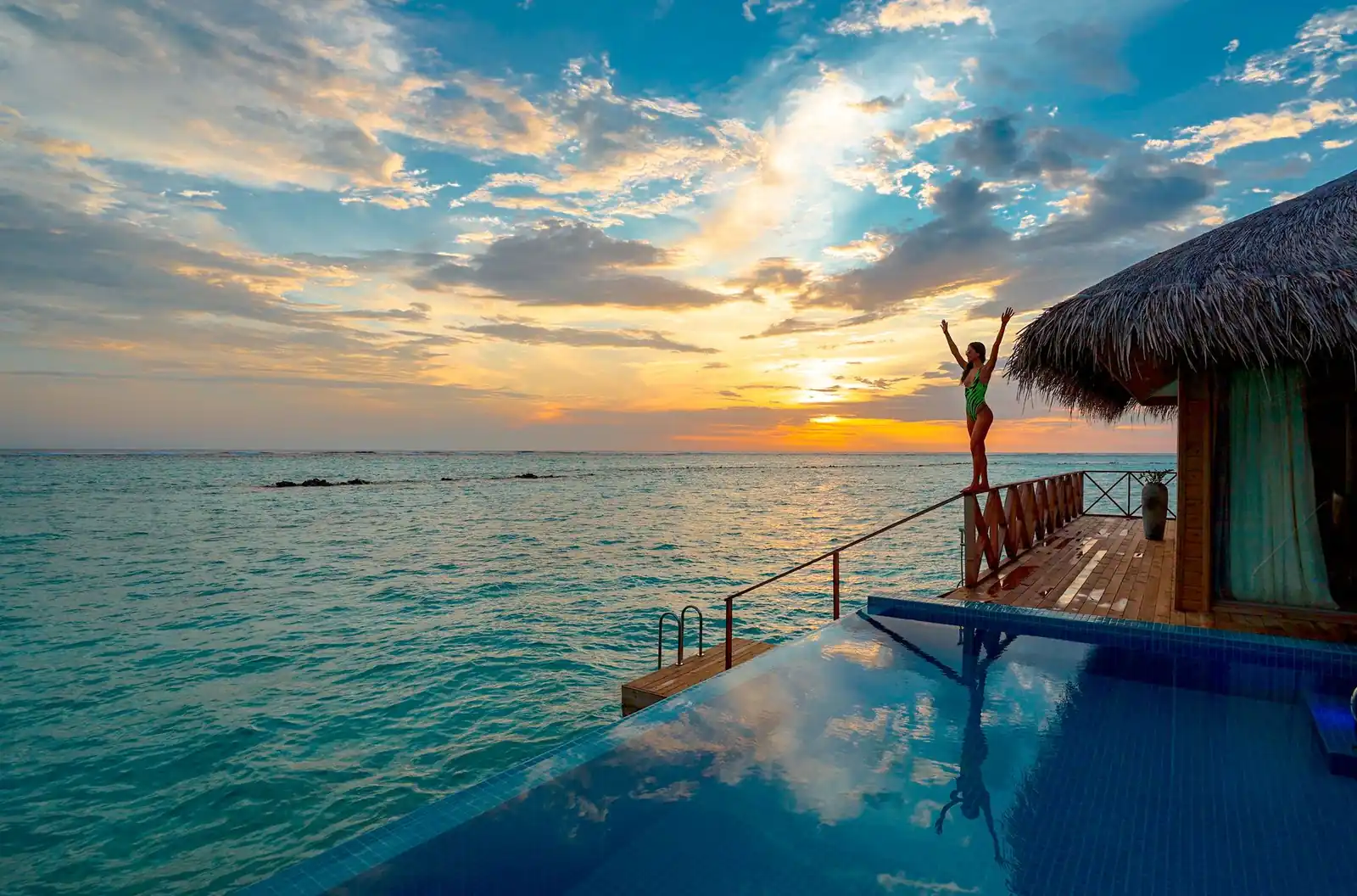 A pool at sunset overlooking open water