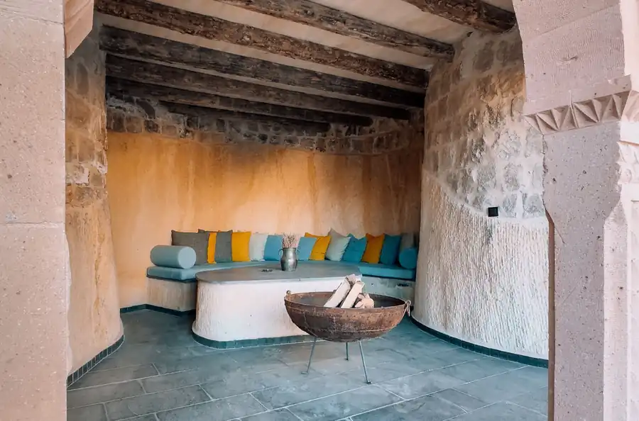 Rustic stone patio with wood beams and seating
