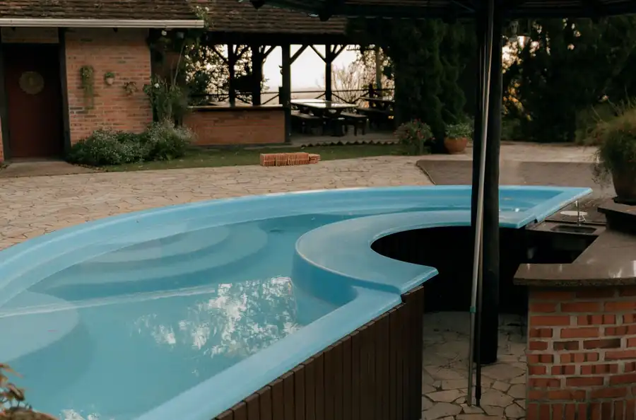 Free form pool with flagstone decking and a shaded gazebo