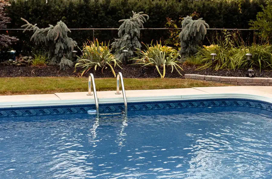 Clear blue pool in a private yard on a sunny day
