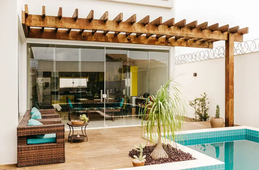 Covered lounge terrace opening onto a pool