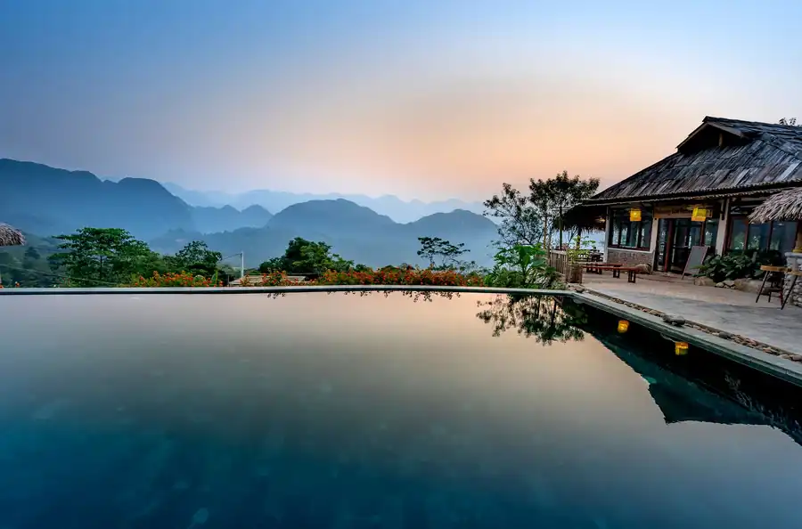 A vanishing-edge pool on a terrace above open landscape