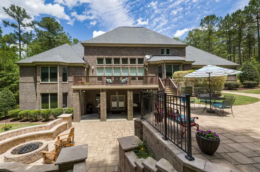 Brick house with a large terrace, fire pit and planted garden
