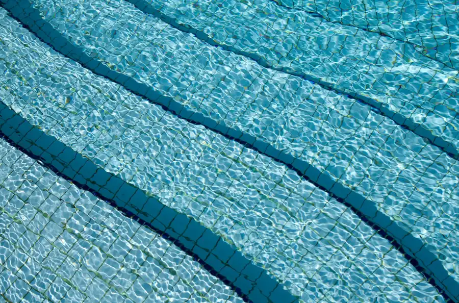 Crystal clear water over the tiled steps of a pool